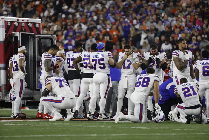 Buffalo Bills players react after teammate Damar Hamlin was injured against the Cincinnati Bengals during the first quarter at Paycor Stadium, Jan. 2, 2023.